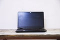 Black laptop on a wooden table 2 Royalty Free Stock Photo