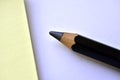 Black large pencil and Notepad on a white background Royalty Free Stock Photo