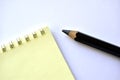 Black large pencil and Notepad on a white background Royalty Free Stock Photo