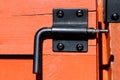 Black latch on Orange door