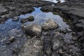 Black lava rock closeup along coast Royalty Free Stock Photo