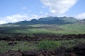 Black lava rocks line the shore at Keanae on the road to Hana in Maui, Hawaii Royalty Free Stock Photo