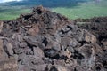 Black lava rocks line the shore at Keanae on the road to Hana in Maui, Hawaii Royalty Free Stock Photo