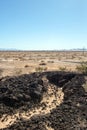 Black lava rocks in the Mojave desert landscape in California USA