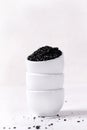 Black lava salt in stack of small bowls Royalty Free Stock Photo