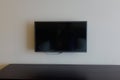 Black LCD or LED tv screen hanging on a wall Royalty Free Stock Photo