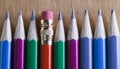 Black lead pencils lie in a row, one pencil has an eraser on the end Royalty Free Stock Photo