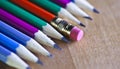 Black lead pencils lie in a row, one pencil has an eraser on the end, small depth of sharpness Royalty Free Stock Photo