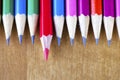 Black lead pencils lie in a row, one pencil has a red core and put forward Royalty Free Stock Photo