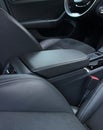 View from rear seats on a stitched leather trim of armrest between front seats inside the car Royalty Free Stock Photo