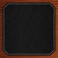 Black leather background on wooden texture Royalty Free Stock Photo