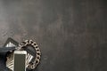 Black leather bag with chain, white phone, zebra print, silver thin rings on a black background. Top view. Copy space