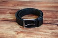 Black leather belt on wooden background Royalty Free Stock Photo