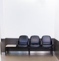 Black leather bench seat row on white wall background in waiting area. Architectural Home or Office Interior, House Furniture,