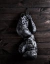 Black leather boxing gloves hanging on a nail Royalty Free Stock Photo