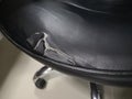 Black leather chair seats have been damaged due to deterioration. Torn to see the foam inside.