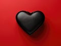 A black leather heart is on a red background Royalty Free Stock Photo