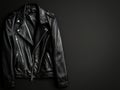 Black leather jacket displayed on a plain black background showcasing its texture and design details Royalty Free Stock Photo