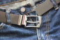 Black leather men`s belt and blue jeans Royalty Free Stock Photo