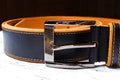 Black leather men`s belt with silver buckle, close up