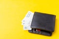 Black leather Men's Wallet with cash on yellow background. Copy space Royalty Free Stock Photo