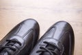 Black leather men shoes on wooden background Royalty Free Stock Photo