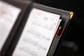 close up of a music score sheet in a black leather folder with pencil Royalty Free Stock Photo