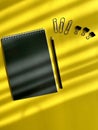 black leather notepad, pencil, paper clips, paper clips on yellow background, business Royalty Free Stock Photo