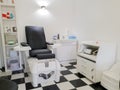 Black leather pedicure chair with professional equipment in beauty salon room. Furniture for spa salons Royalty Free Stock Photo