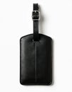 Black leather rectangular luggage tag with silver buckle isolated on white background. Accessory essential for travel Royalty Free Stock Photo