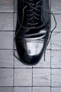 A black leather shoe with laces untied Royalty Free Stock Photo