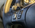 Black, leather steering wheel of a modern car with sound control buttons. Royalty Free Stock Photo