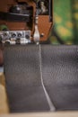 Black Leather Stitching in Front of a Commercial Sewing Machine
