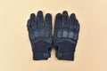 black leather and textile gloves for riding a motorcycle or bicycle