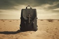 Black leather travel bag with cross on the sand in desert. Missionary work