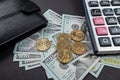 black leather wallet with dollar bills of various denominations calculator on black background Royalty Free Stock Photo