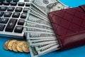 black leather wallet with dollar bills of various denominations calculator on black background Royalty Free Stock Photo