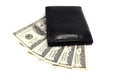 Black leather wallet on a fan of dollars isolated on a white background Royalty Free Stock Photo