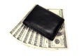 Black leather wallet on a fan of dollars isolated on a white background Royalty Free Stock Photo