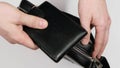 Black leather wallet in a man handbag. Close up.