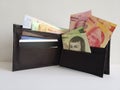 black leather wallet with mexican banknotes and white background Royalty Free Stock Photo