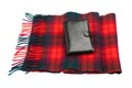 Black leather wallet and wool tartan scarf Royalty Free Stock Photo