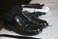 Black leather wingtip mens dress shoes with black socks and belt Royalty Free Stock Photo