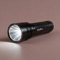 Black LED flashlight on brown background. Royalty Free Stock Photo
