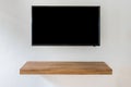 Black LED tv television screen on white wall background with modern wooden table Royalty Free Stock Photo