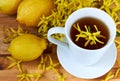 Black lemon tea decorated with yellow forsythia flowers