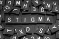 Black letter tiles spelling the word & x22;stigma& x22; Royalty Free Stock Photo