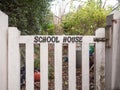 black lettering school house white picket gate fence country house close up