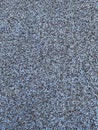 Black and light blue shock absorbing rubber crumb coating. color grainy background texture. soft coating for recycled rubber Royalty Free Stock Photo