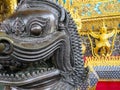 Black lion statue with golden garuda holding naga and ornamental